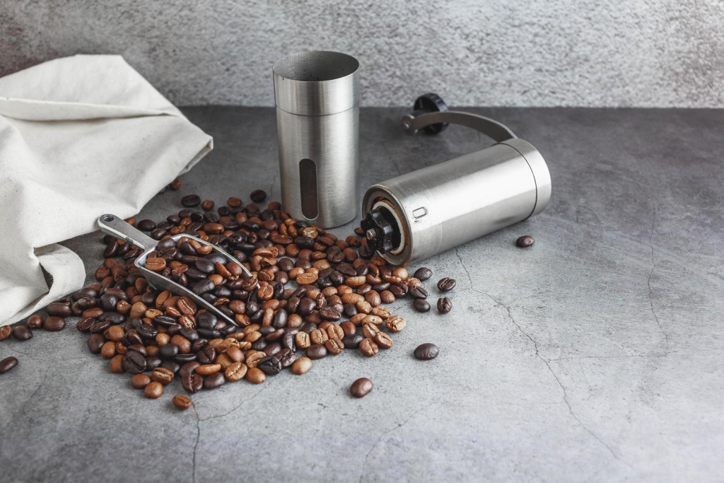 hand-coffee-grinder-and-coffee-beans-on-the-table-free-photo.jpg