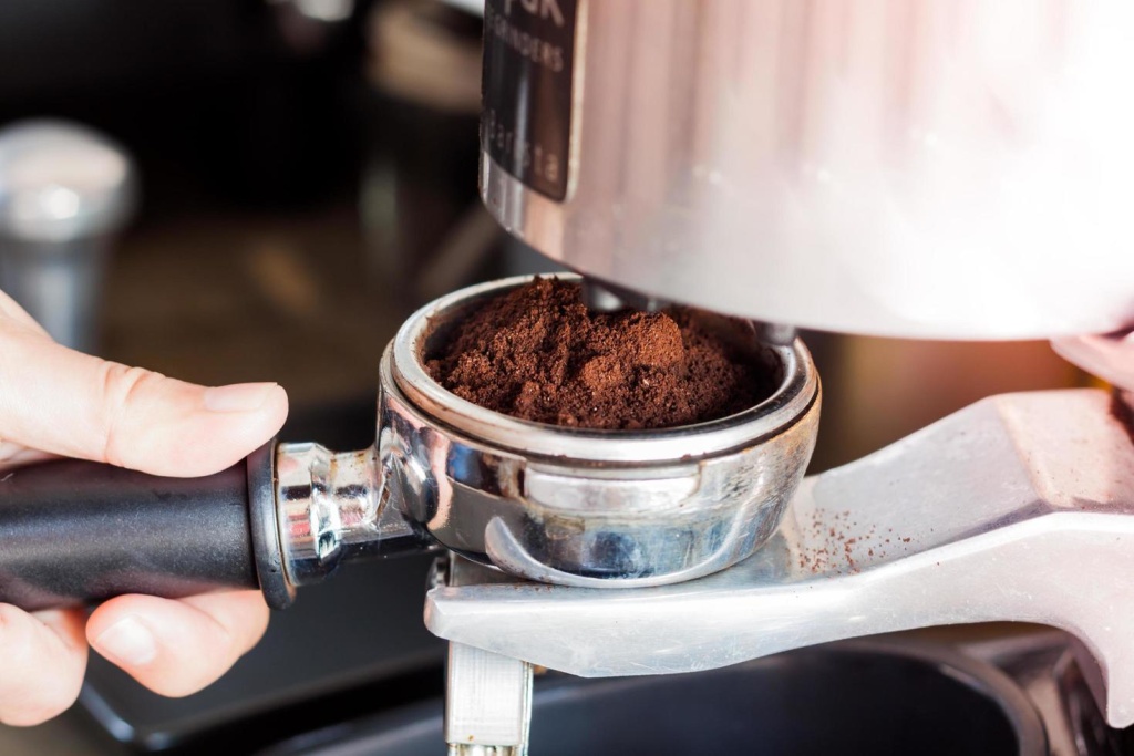 close-up-of-a-hand-holding-a-coffee-grinder-free-photo.jpg