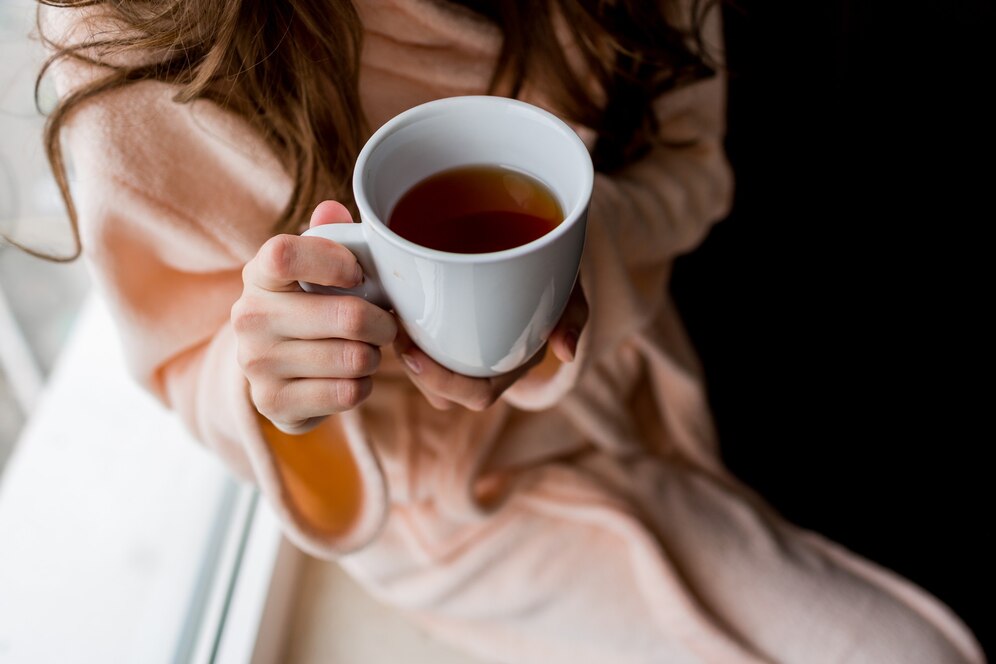 woman-bathrobe-holding-cup-hot-tea-outumn-mood_273443-3101.jpg