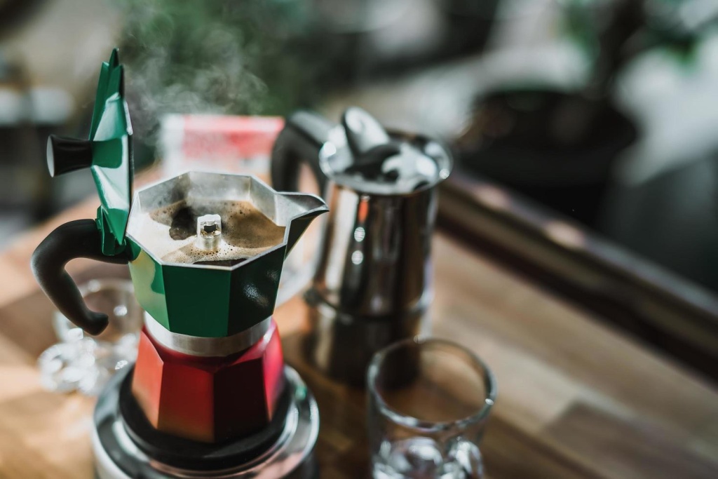 hot-coffee-in-moka-pot-on-electric-stove-vintage-coffee-maker-on-wooden-table-at-home-selective-focus-free-photo.jpg