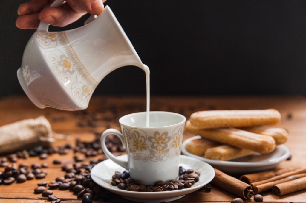 crop-hand-pouring-milk-into-cup_23-2147764919.jpg