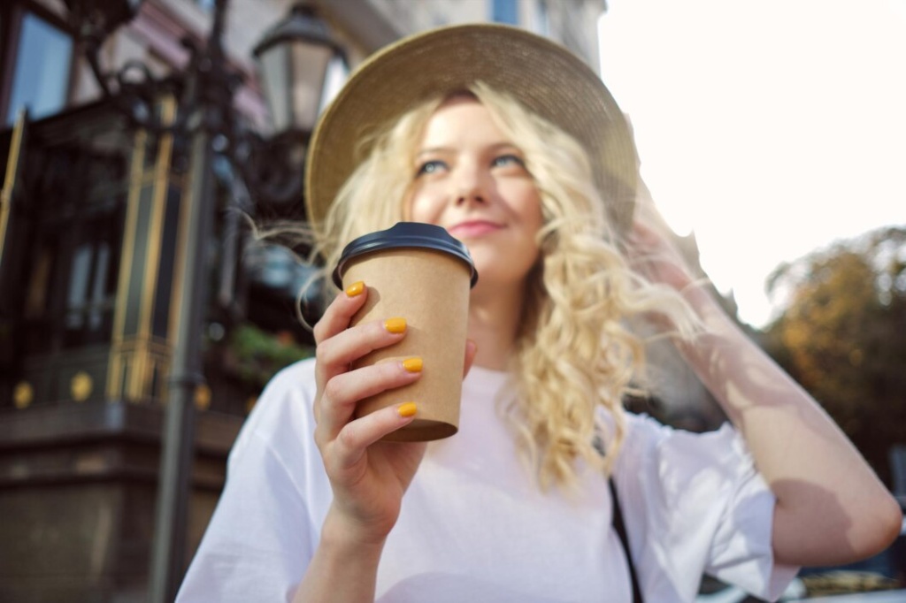fuzzy-portrait-attractive-casual-blond-girl-hat-dreamily-looking-away-with-coffee-go-hand-city-street_574295-4090.jpg