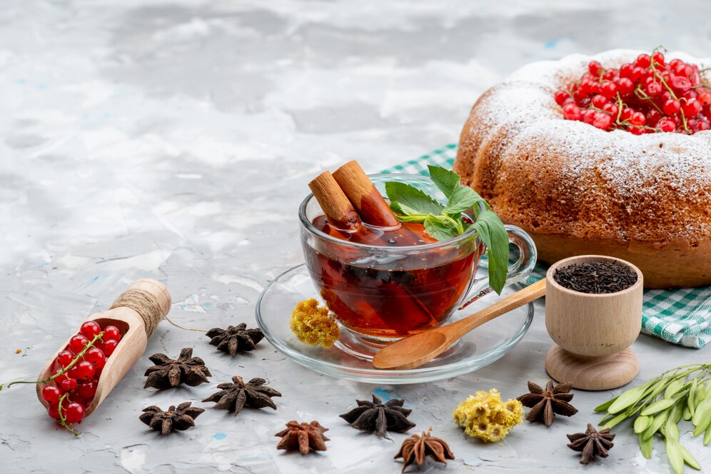 front-view-fresh-red-cranberries-sour-mellow-with-round-cake-tea-cinnamon-white-desk-fruit-berries_140725-21814.jpg