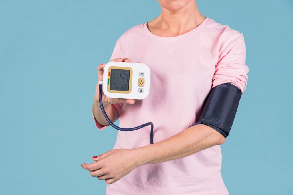 woman-showing-results-blood-pressure-electric-tonometer-screen_23-2148032344.jpg