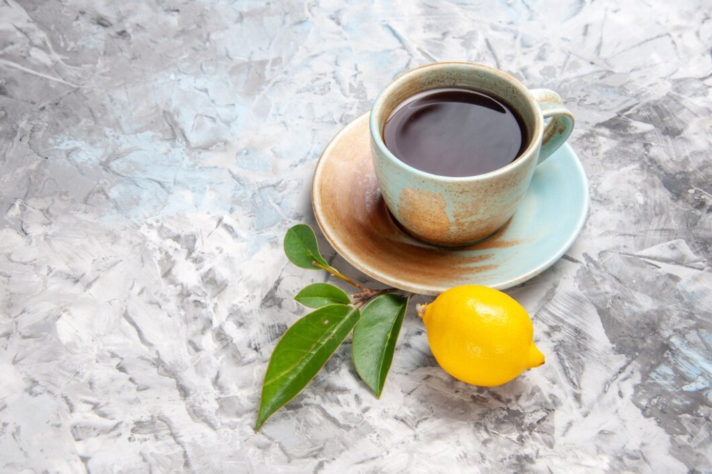 front-view-cup-tea-with-lemon-white-table-fruit-tea-drink_140725-123857.jpg